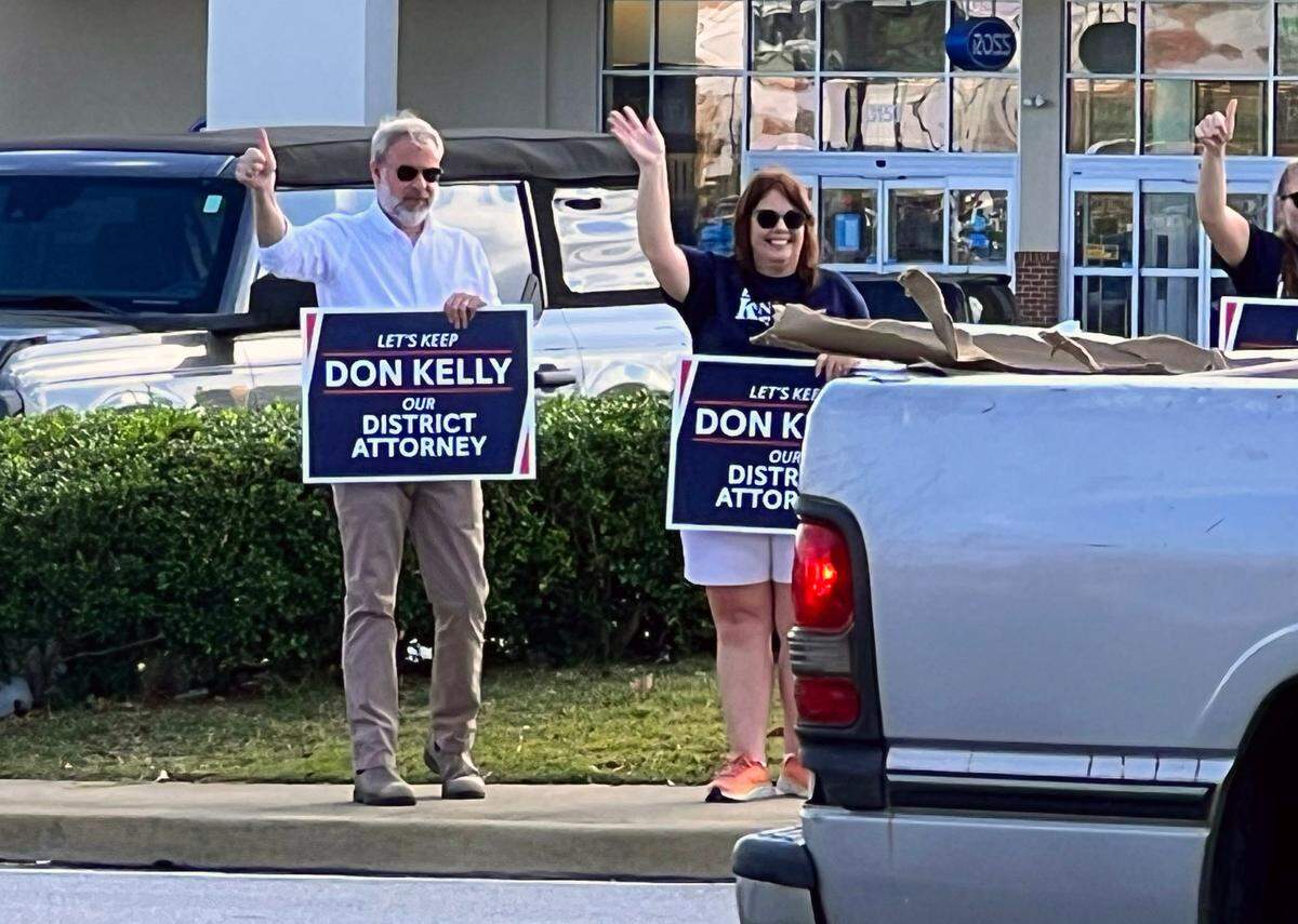 Don Kelly, far left, acting district attorney for the Chattahoochee Judicial Circuit District and on the ballot to stay in office, was out waving at traffic on Macon Road across from Synovus near ​Synovus Bank branch near the Columbus Public Library precinct. 11/05/2024