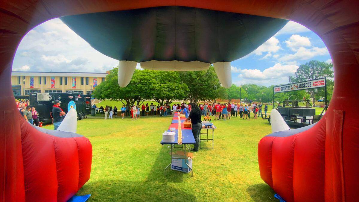 Columbus State University’s Archives & Special Collections arranged for the creation and serving of a 50-foot-long scrambled dog made by Country’s BBQ to students and employees on Thursday afternoon at the foot of the clock tower on CSU’s main campus.