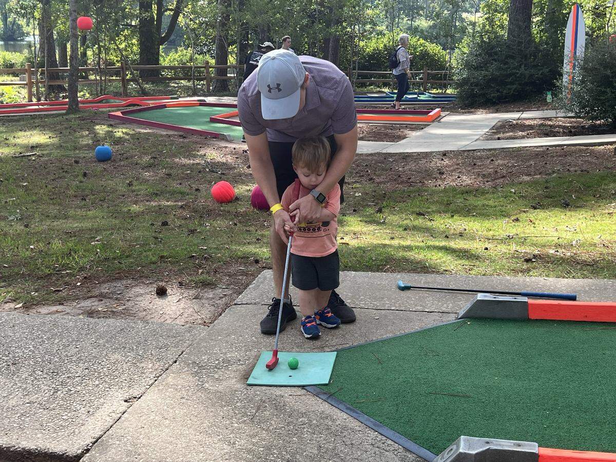 Lee Rensch and his son Lincoln play Glow Golf at Pumpkins at Callaway on Sept. 16. The attractions is set to run every Friday, Saturday and Sunday through Oct. 30.