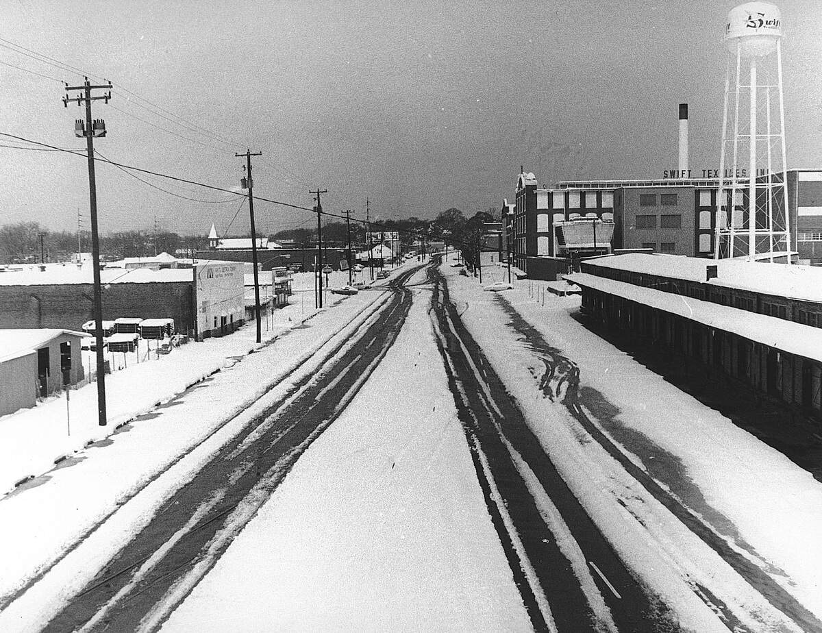 The great snow storm of 1973 began February 9 and dumped fourteen inches of snow on Columbus, Georgia before it was over. This is a view looking north along Sixth Avenue in Columbus.
