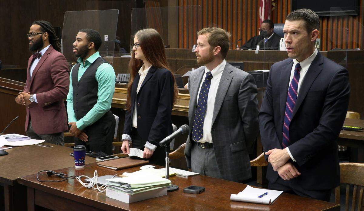Defendants Erik Whittington, second from left, and Mark Jones, right, and their attorneys stand as jurors enter the court Tuesday morning in Columbus, Georgia.