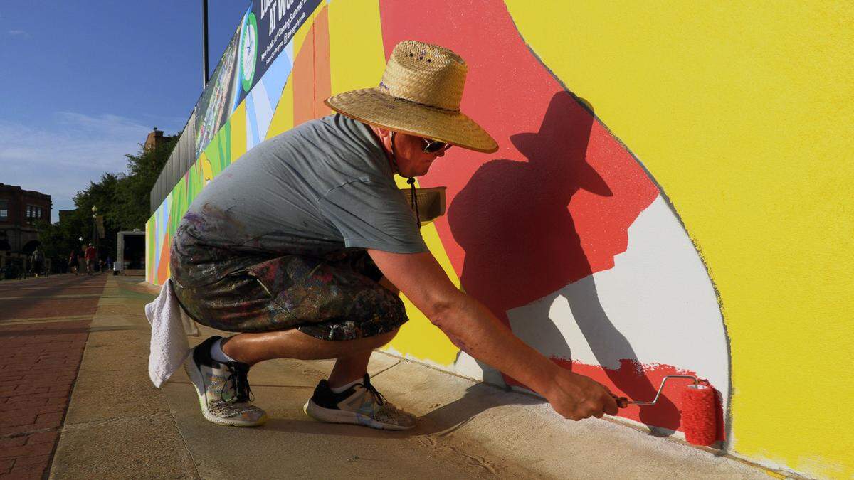 Chris Johnson, a muralist and retired Andrew College professor of art, is leading the design team in painting a mural along the Chattahoochee Riverwalk.The mural stretches along the riverbank’s three-tiered retaining wall where the Synovus Centre, 1111 Bay Ave., overlooks the Riverwalk between two of the most popular attractions on the riverfront: Waveshaper Island and Woodruff Park. 06/15/2023