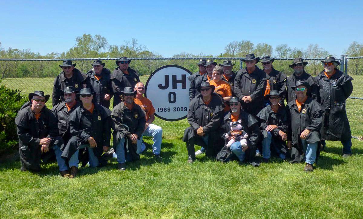 Miracle Riders gather next to a sign on the campus of Missouri Southern State University honoring Jonathan Hansen, a soccer player at Missouri Southern who died in February 2009 after collapsing on the court during an intramural basketball game on campus. Then 22, Jonathan was a senior goalkeeper on the men’s soccer team. His father, Brad Hansen, is a Miracle Rider.