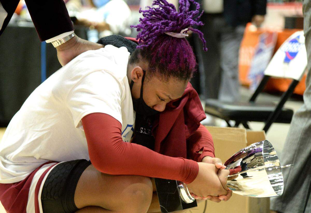 CarverÕs Kionna Gaines (15) takes a moment with the championship trophy after the TigersÕ 70-54 win over Cairo in the GHSA 4A State Championship Wednesday in Macon.