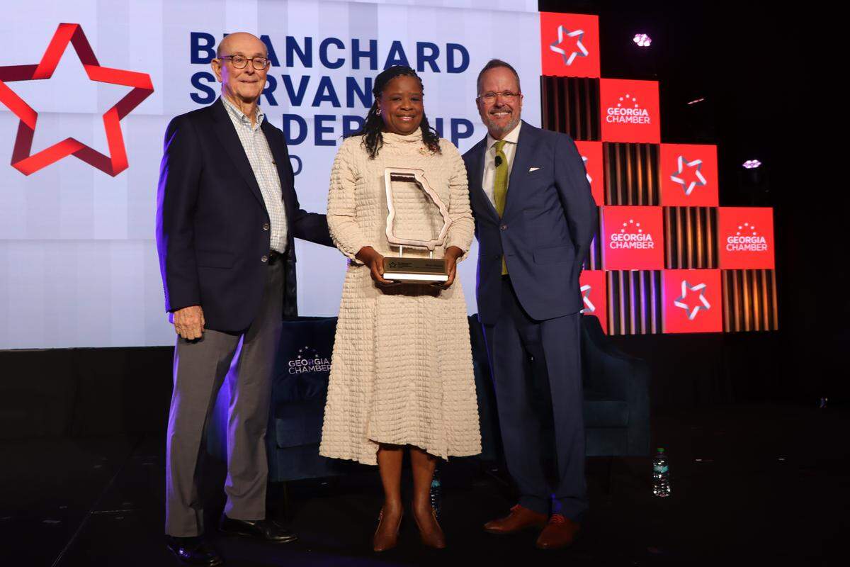 The Georgia Chamber of Commerce named Shan Cooper as the recipient of the 2025 Blanchard Servant Leadership Award at the 2025 Congressional Luncheon Aug. 20, 2025, in the Columbus Convention & Trade Center. Pictured with Cooper are, from left, retired Synovus chairman and CEO Jim Blanchard and Georgia Chamber of Commerce president and CEO Chris Clark. Cooper is the founder and CEO of Journey Forward Strategies LLC, a solutions-focused consulting firm that partners with organizations committed to improving and achieving sustainable results by ensuring alignment between their business and people strategies.