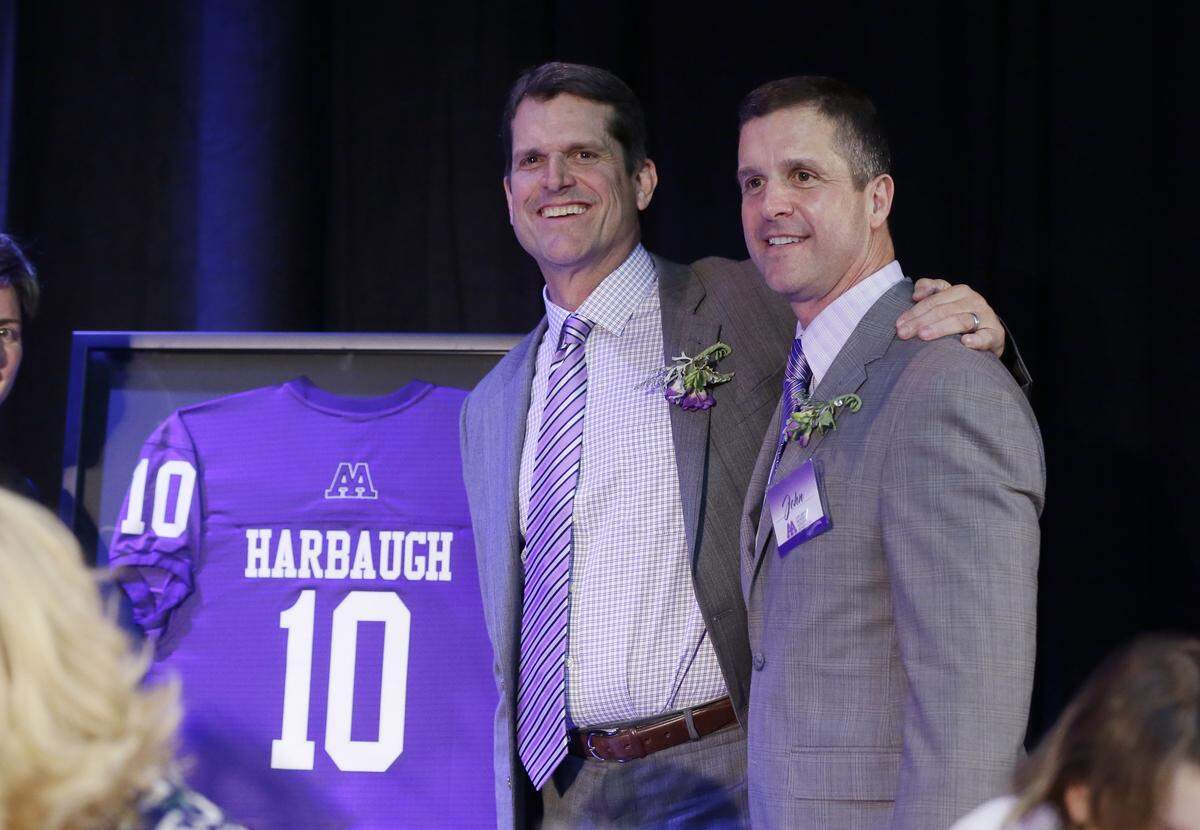 Michigan head football coach Jim Harbaugh, left, stand with his brother Baltimore Ravens head coach John Harbaugh, after his induction into the Ann Arbor Pioneer High School Hall of Fame. The Harbaughs maintain a close relationship with Crean, who is married to their sister Joani.