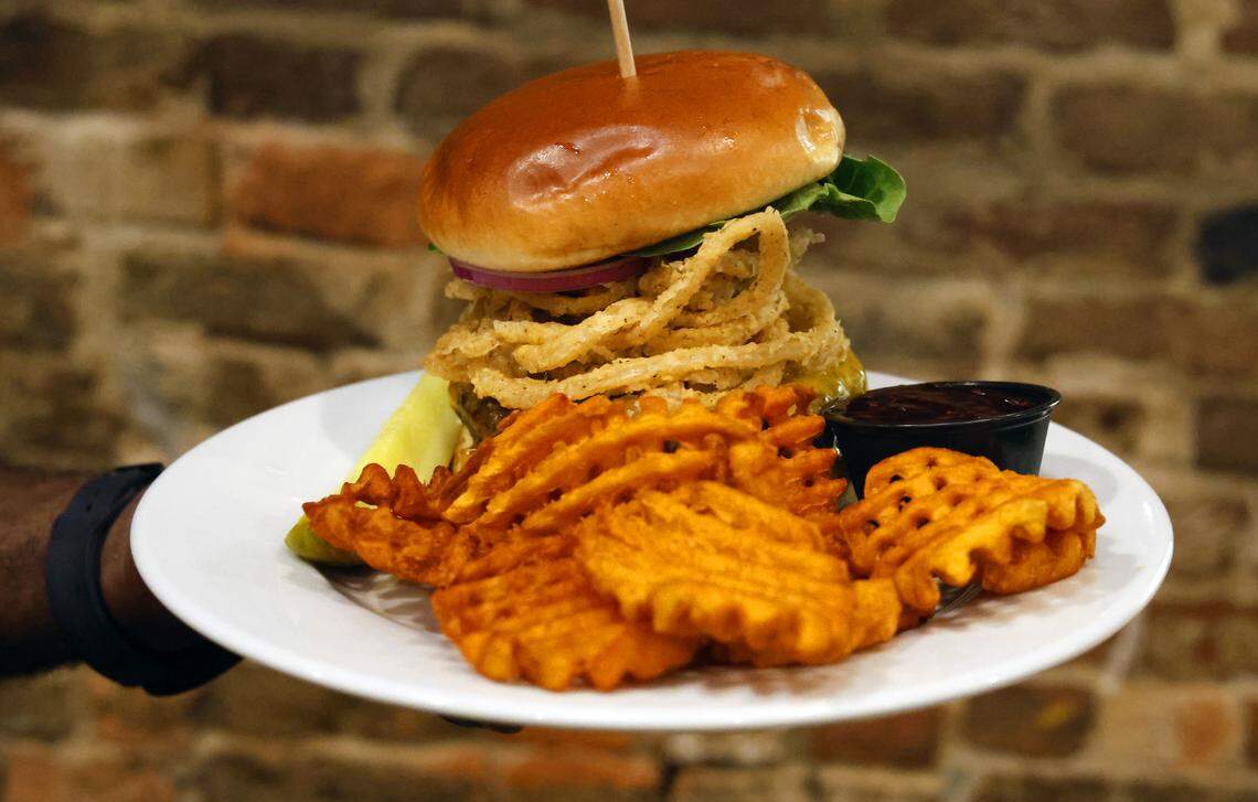 The Cannon Brew Pub in Columbus, Georgia offers several burgers, including the Bama Burger. It’s a 10 oz. black angus beef burger topped with chipotle barbecue sauce, fried beer onions and cheddar cheese. It’s served on a brioche bun. 08/05/2025