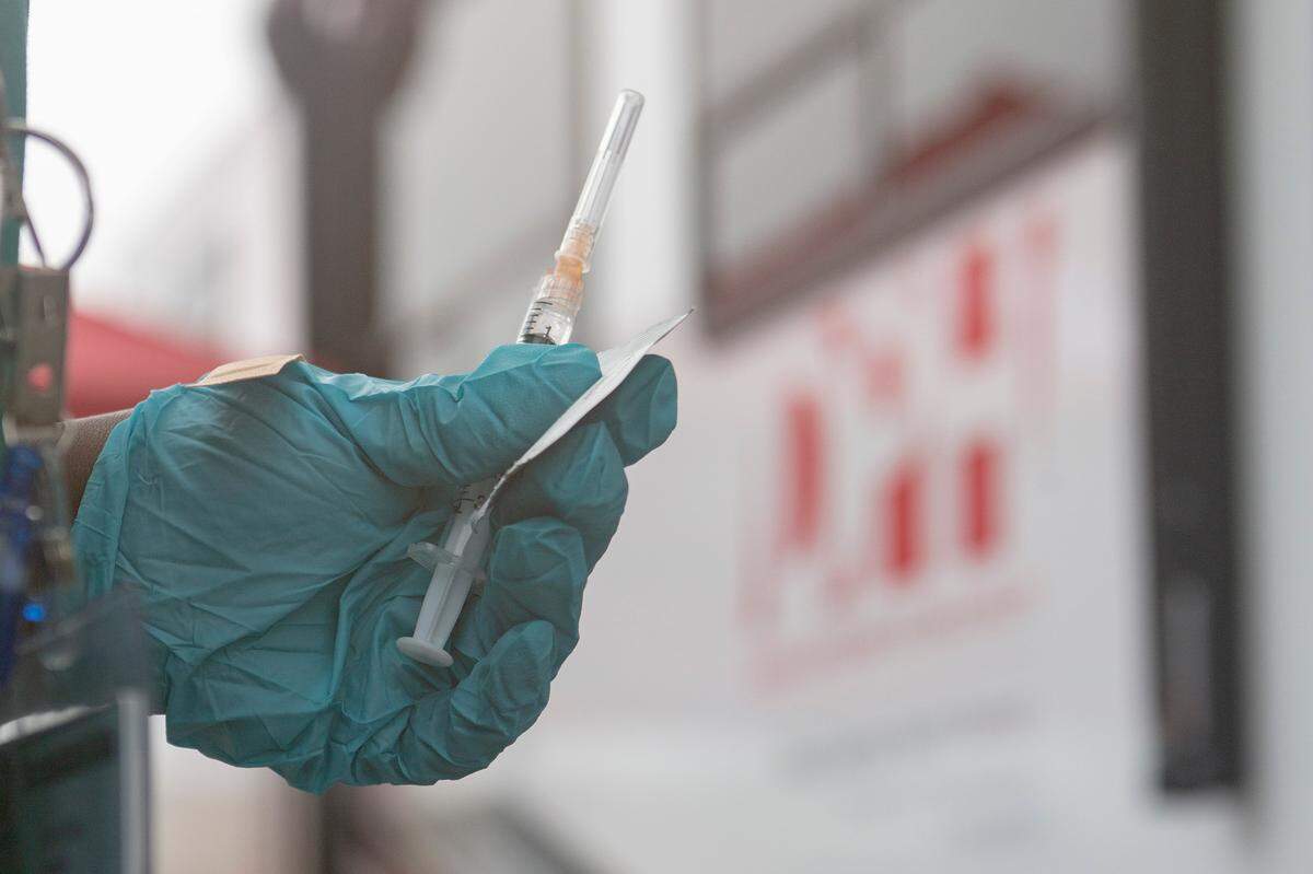 Physician assistant Wyvitra Stokes prepares a COVID-19 vaccine at the West Central Health District’s mobile unit on Dec. 7, 2021, in Columbus, Ga.