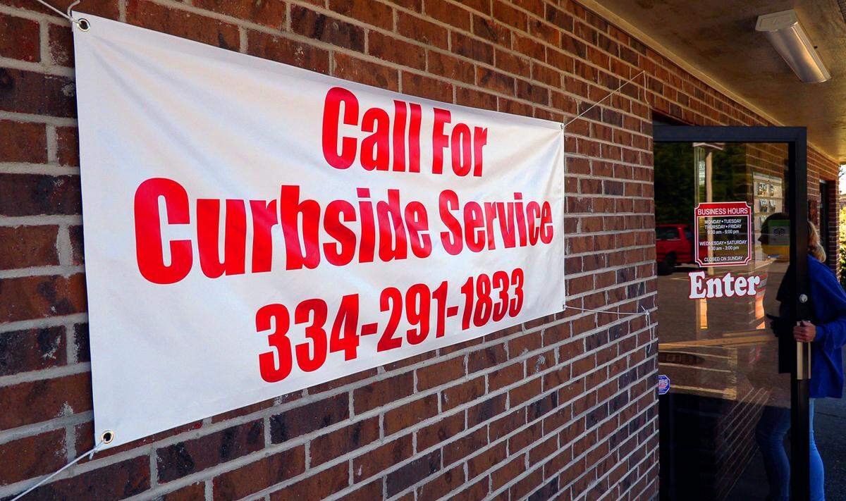 A customer enters 13th Street BBQ, which is off 13th Street at 1310 17th Ave., in Phenix City, Alabama. Owner Slay Johnson said take-out orders have kept the restaurant going, though business is not at its usual pace.
