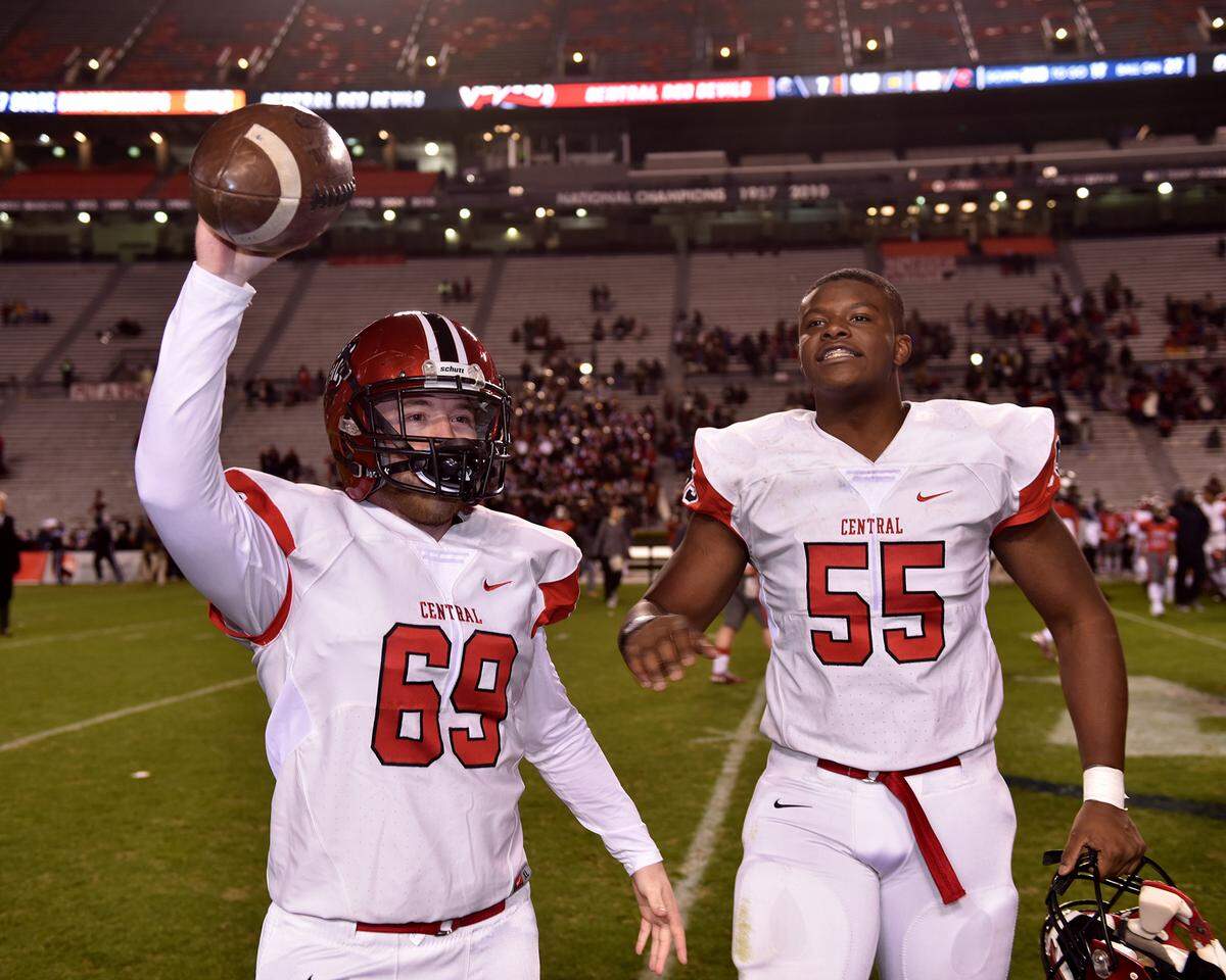 Central senior offensive lineman Justin Fowler (69) and junior offensive lineman Javion Cohen (55) celebrate the Red Devils winning of the Alabama High School Athletic Association Class 7A football state championship after the 52-7 victory over Thompson in Jordan-Hare Stadium at Auburn University on Wednesday night, December 5, 2018.