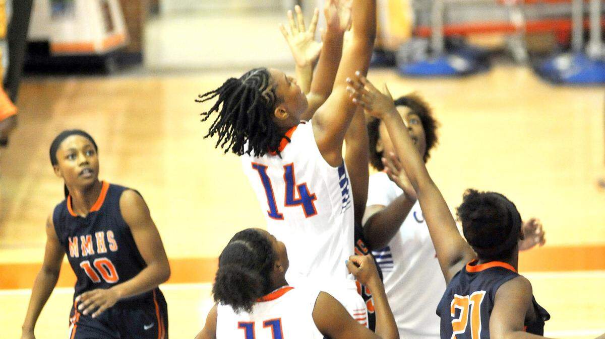 Columbus' Tatyana Wyatt taking the ball to the hoop against Mundy's Mill Tuesday night during the 1st round of the GHSA State Playoffs February 16, 2016