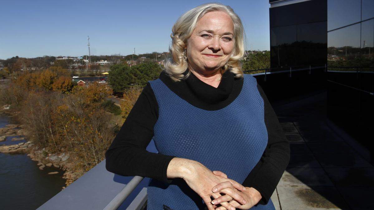 Debbie Avery is associate director of facilities for TSYS, the global credit-card and payments processor headquartered in Columbus. She is shown on the fourth floor of the corporate headquarters building, with the Chattahoochee River over her shoulder.