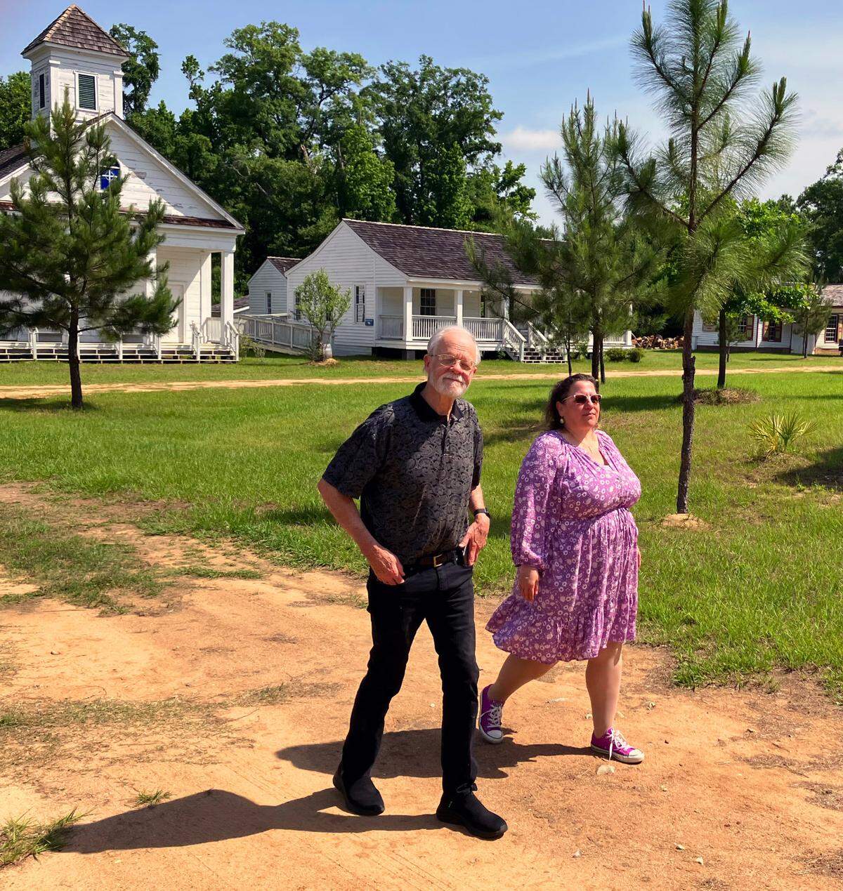 Historic Westville Village board president Thornton Jordan, left, and new Historic Westville Village executive director April Kirk walk through the living history museum in Columbus on May 16, 2025.