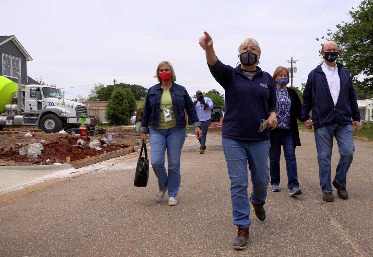 Cathy Williams, president and CEO of NeighborWorks Columbus, leads a tour of Highland Homes on Fourth. The Highland Homes community features 25 new houses and are located in the Mill District in Columbus.