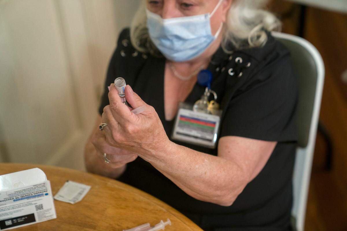 A Georgia Department of Public Health healthcare worker prepares a dose of the Johnson & Johnson COVID-19 vaccine on Thursday, April 8, 2021 at Safehouse Ministries in Columbus, Ga.