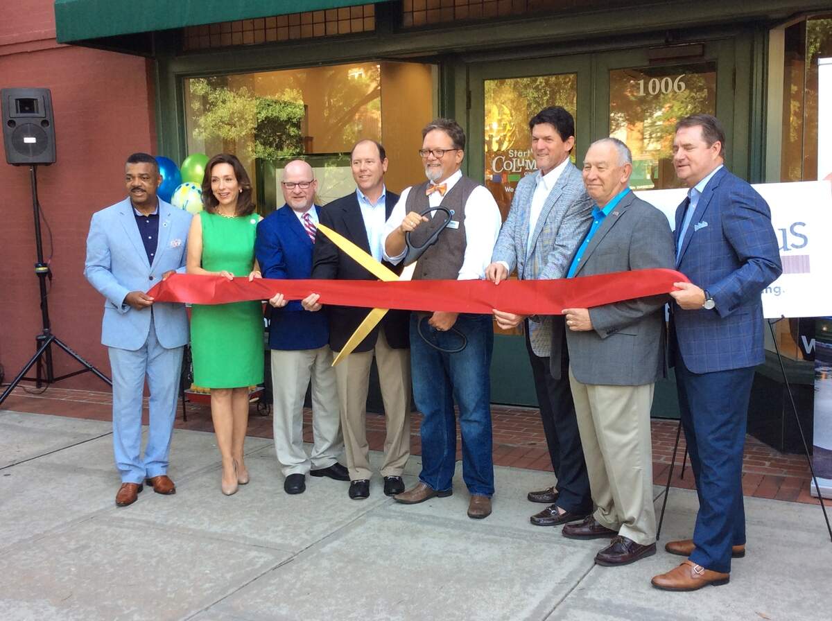 Shown cutting the ceremonial ribbon Friday at 1006 Broadway, the new home for StartUP Columbus, is (l-r) Columbus City Manager Isaiah Hugley, Columbus Mayor Teresa Tomlinson, Columbus State University President Chris Markwood, Columbus 2025 Chairman Billy Blanchard, StartUP Columbus Chief Entrepreneurial Officer Frank Braski, Columbus Development Authority Chairman Russ Carreker, Troy University-Phenix City Vice Chancellor David White, and Greater Columbus Chamber of Commerce President and CEO Brian Anderson.