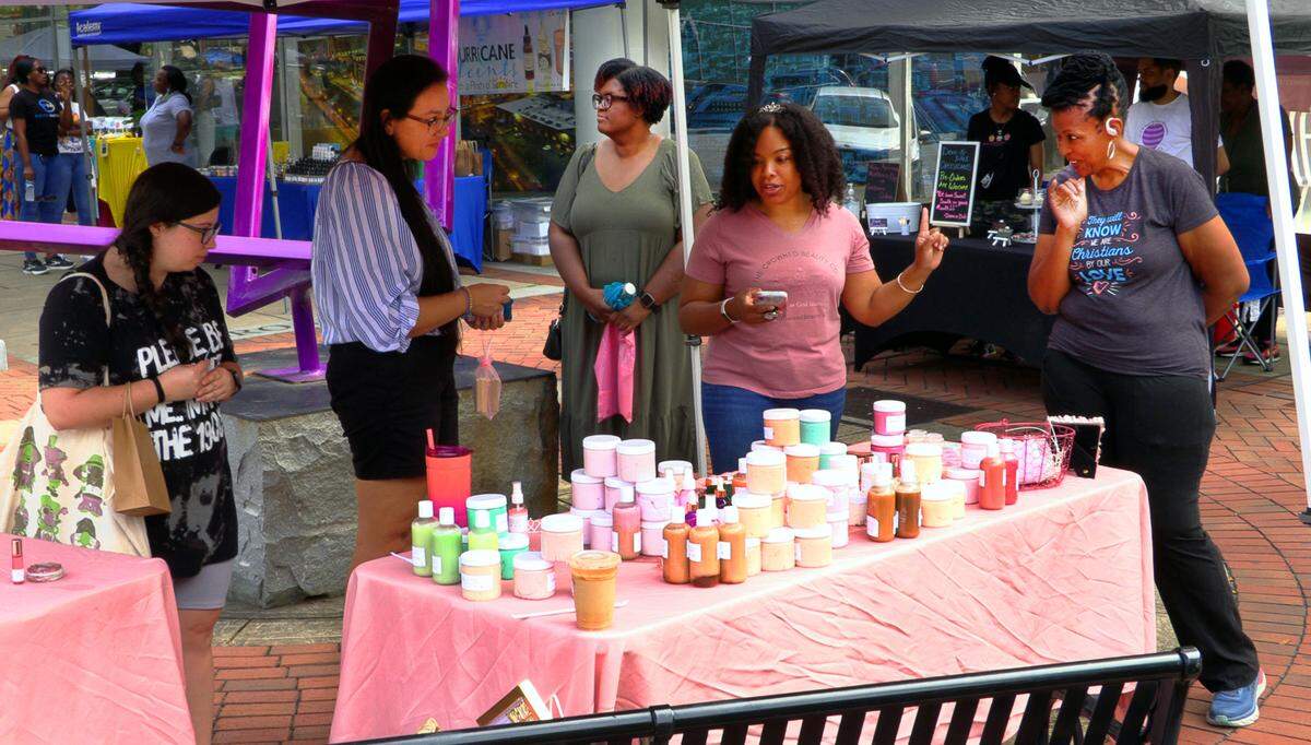 Kristi Pitts, second from right, the owner of The Crowned Beauty Co., is preparing to open a brick-and-mortar Crowned Beauty Co. store in downtown Columbus in the Rankin Building on 10th street later this month. She will continue to offer her products during Market Days on Broadway. 05/04/2024
