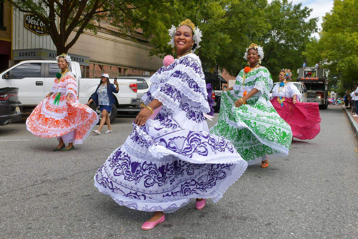 Parade participants walk down Broadway during the Tri-City Latino Festival parade through downtown Columbus on Sept. 17, 2022.