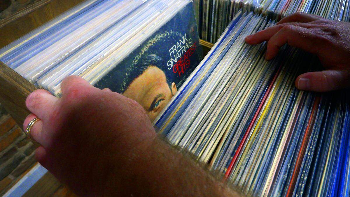 Brian Cook, the owner of Blue Canary Records in Columbus, Georgia, flips through his extensive selection of Frank Sinatra records. 07/13/2023