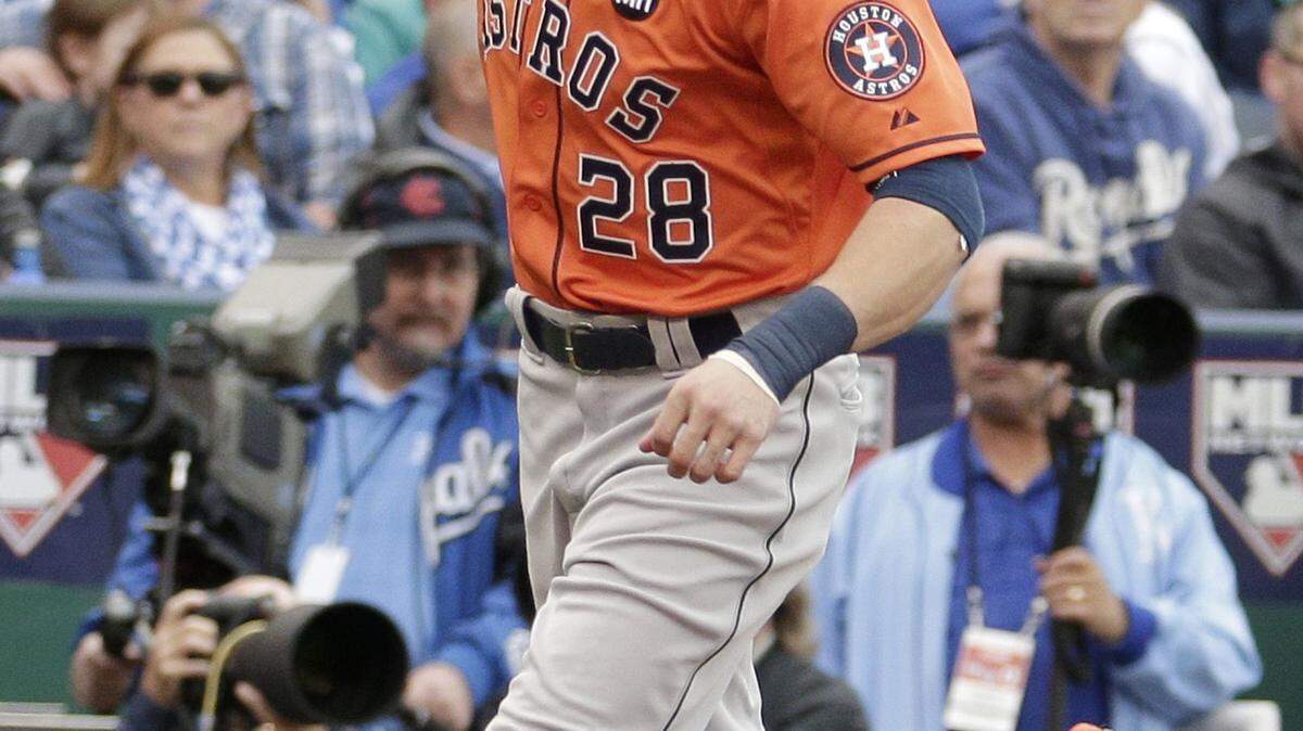 Houston Astros' Colby Rasmus reacts as he runs the bases after hitting a solo home run during the third inning of Game 2 in baseball's American League Division Series against the Kansas City Royals, Friday, Oct. 9, 2015, in Kansas City, Mo. (AP Photo/Charlie Riedel)