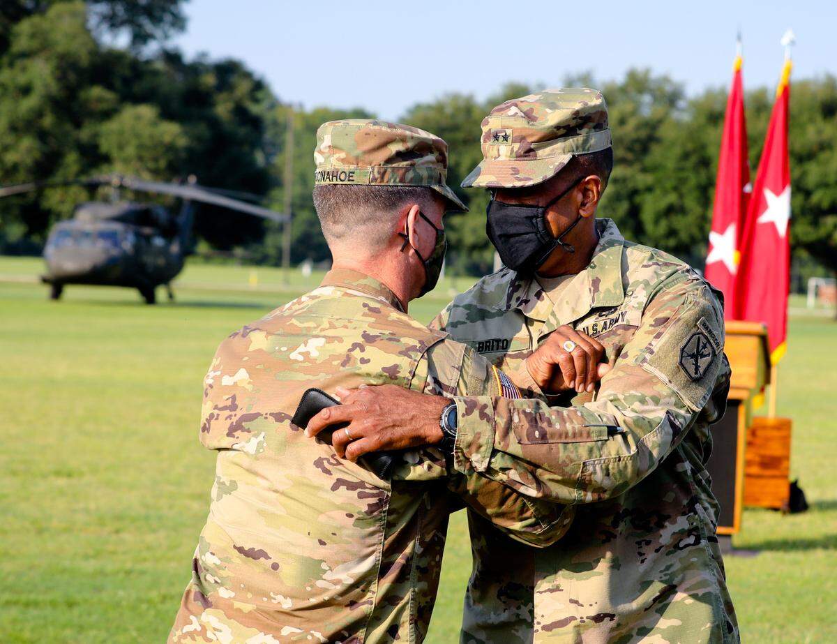 Maj. Gen. Patrick J. Donahoe, left, assumes command of the Maneuver Center of Excellence, Fort Benning from Maj. Gen. Gary M. Brito July 17, 2020 on York Field. Lt. Gen. James E. Rainey was the reviewing officer.