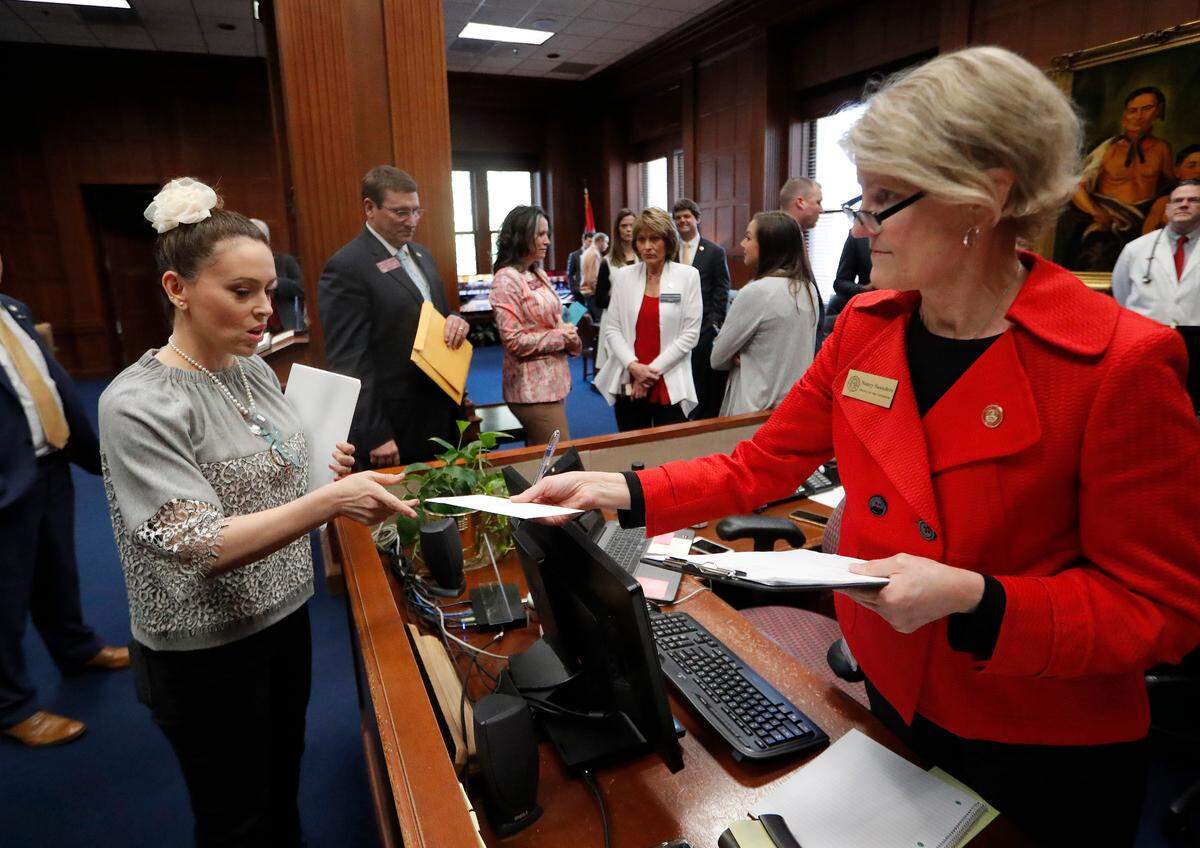 Actress Alyssa Milano, left, delivers a letter to Georgia Gov. Brian Kemp’s office detailing her opposition to HB 481 at the State Capitol in Atlanta on Tuesday. HB 481 would ban almost all abortions after a fetal heartbeat can be detected.