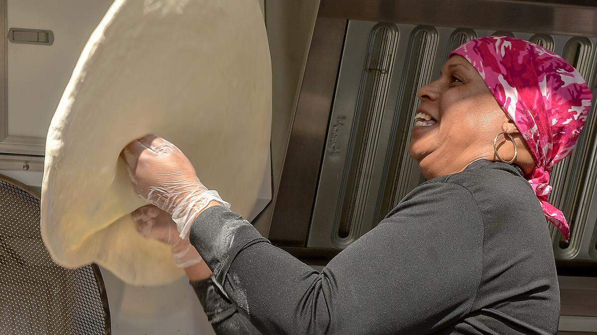 Lansonia Terrence tosses pizza dough at Triple Jays Pizzeria food truck for the Uptown Spring Food Truck Festival Saturday, March 30, 2019. Triple Jays planned to sell between 300 to 400 pizza slices during the festival. With food, beer, music and access to a playground, it was an event that attracted people of all ages and their animals too. With Uptown Columbus anticipating 30 food trucks for the event and several craft breweries, it was to be the biggest food truck festival they have had so far.