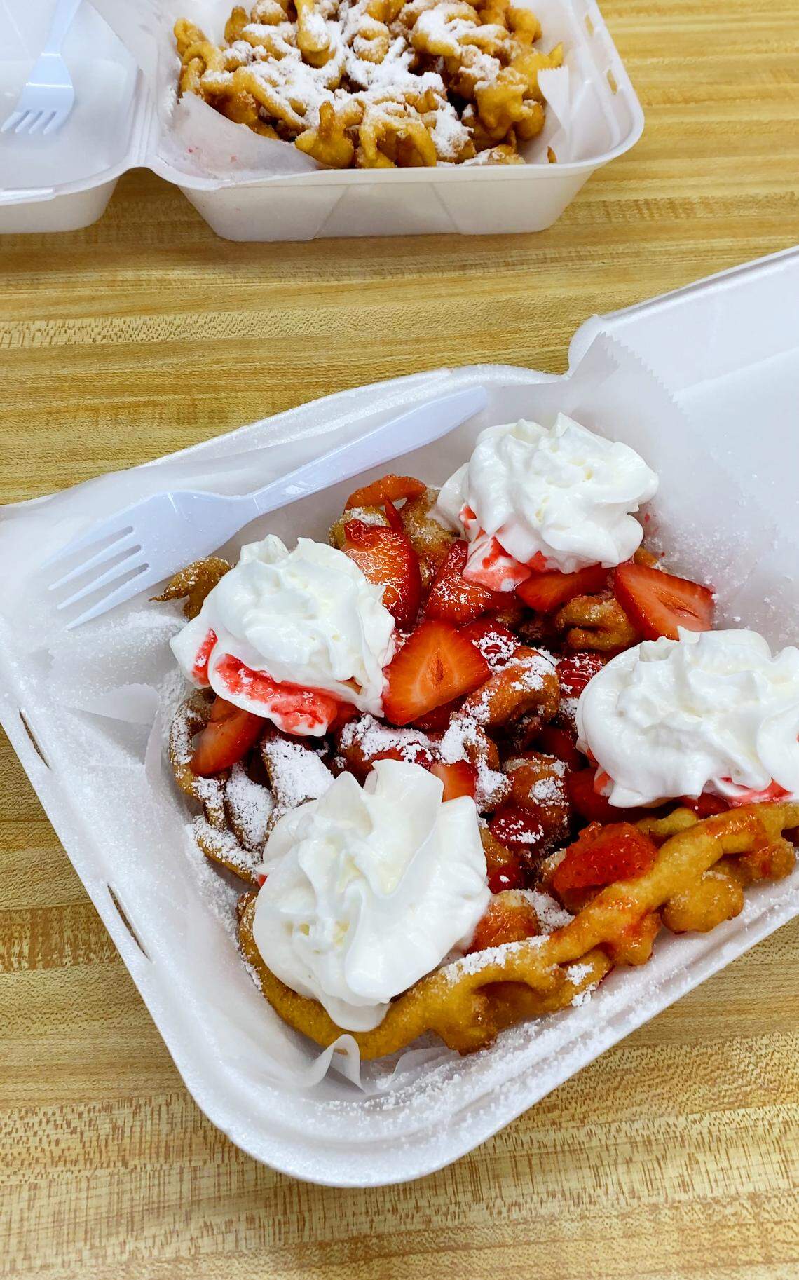 Da Funnel Cake Factory, 1128 Fort Benning Road Suite D in Columbus, Georgia, offers a variety of different funnel cakes, including the Sam’s Strawberry, front, and atraditional one with powdered sugar.
