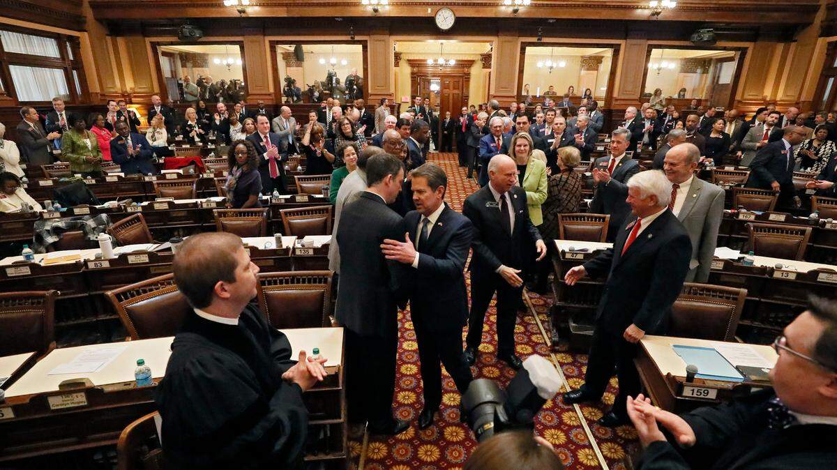 Georgia Gov. Brian Kemp is greeted as he enters the House Chambers to deliver his first State of the State address Thursday in Atlanta.