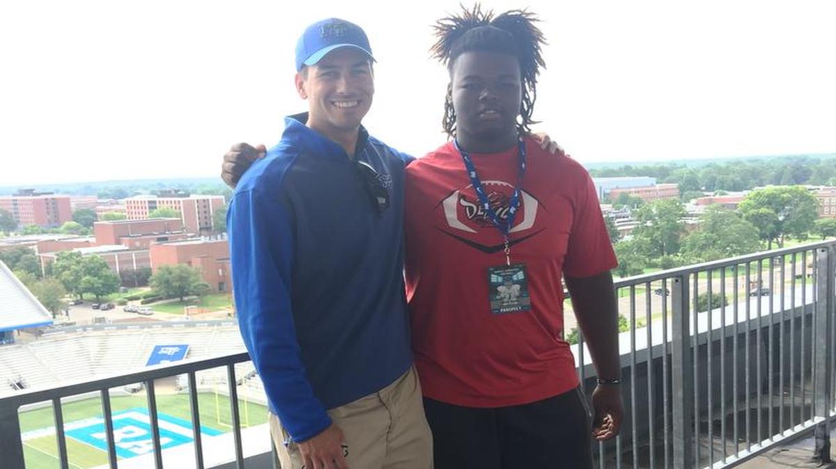 Central offensive lineman Jahlil Ryles and MTSU wide receivers coach Austin Silvoy pose together during Ryles’ visit to the school.