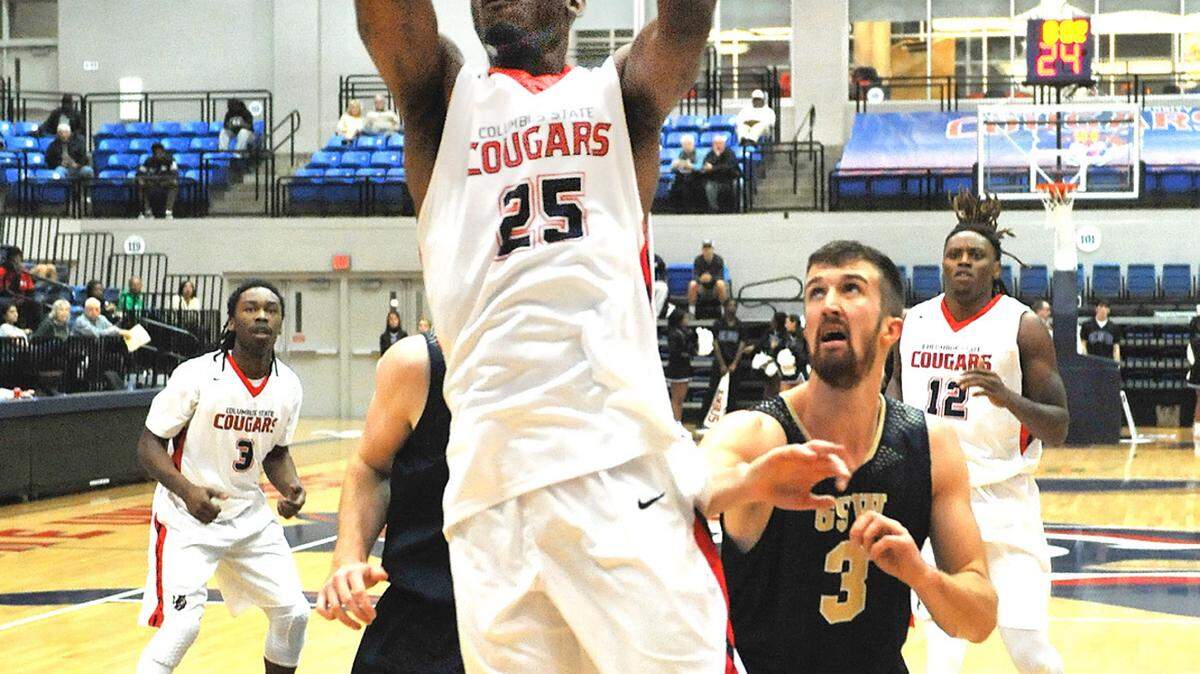 CSUís Demarcus McVay takes the pass from Cam Baker turns and hits the easy dunk against the Georgia Southwesternís defenders in the 2nd period of the game Thursday night at the Lumpkin Center, Jan 7, 2016