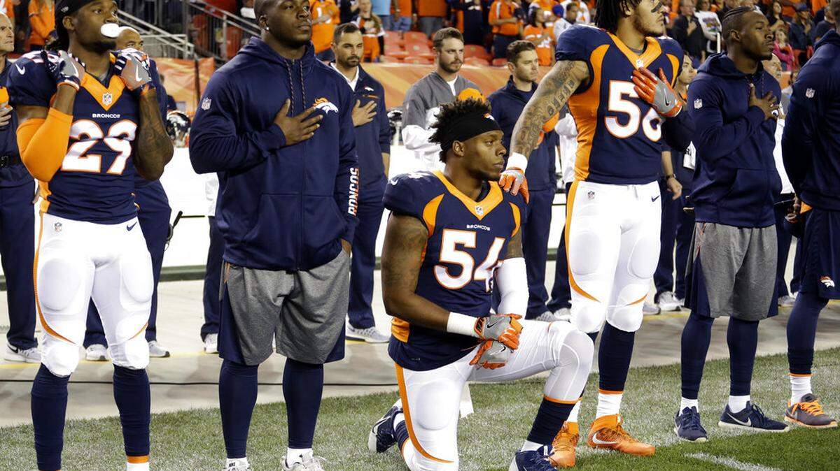 FILE - In this Monday, Oct. 24, 2016, file photo, Denver Broncos inside linebacker Brandon Marshall (54) takes a knee during the national anthem prior to an NFL football game against the Houston Texans, in Denver. Marshall said the NFL can show its support of its players by hiring quarterback Colin Kaepernick. He's the one who started the national anthem protests last year to bring attention to racial inequality. 
