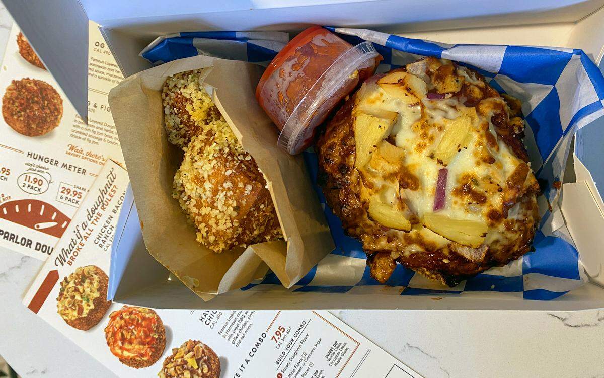 Ledger-Enquirer visual journalist Mike Haskey ordered the Savory Combo at Parlor Doughnuts in Columbus on Jan. 22, 2026. For his combo, he selected the Hawaiian BBQ Chicken doughnut, the Parmesan Minis and the red sauce dip.
