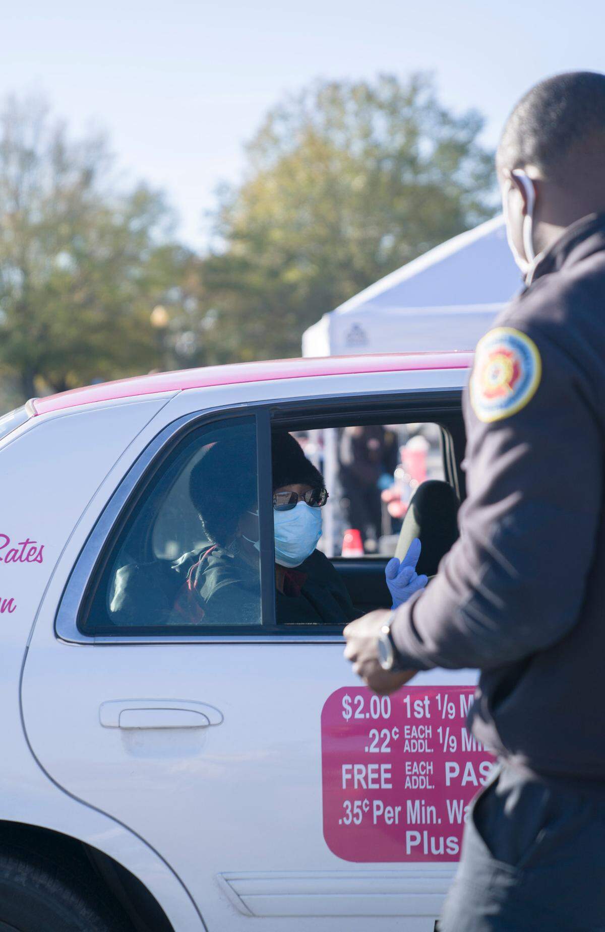 A woman took a taxi to the Civic Center to be vaccinated at the community testing site in Columbus, Ga. on Saturday, Jan. 23, 2021.