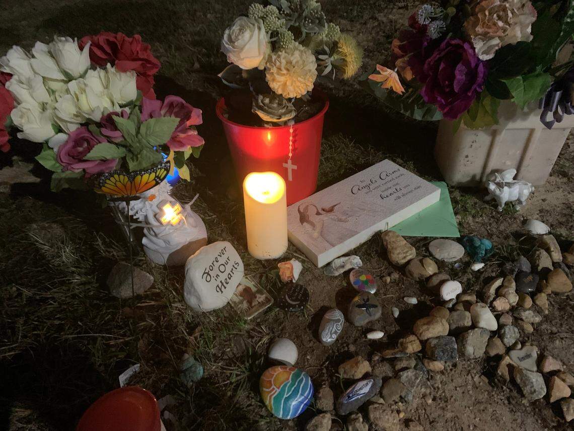 An electric candle is lit at a memorial for Gisele Lara who was killed in an apparent murder-suicide on Columbus State University’s main campus.
