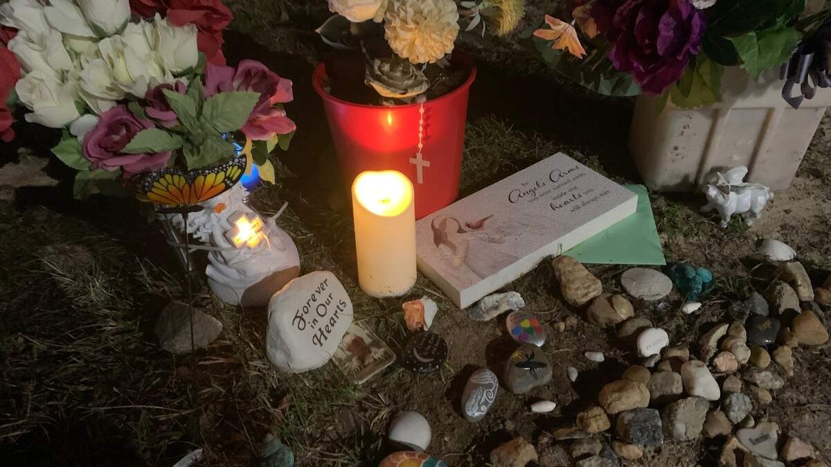 An electric candle is lit at a memorial for Gisele Lara who was killed in an apparent murder-suicide on Columbus State University’s main campus.