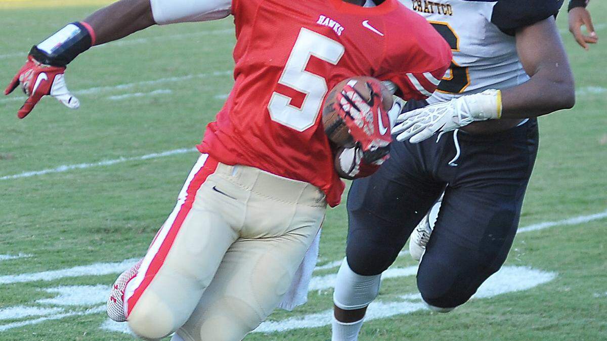 Hardaway's Christian McBride pursued out of the backfield by Chattahoochee County's Justin Dore 2nd quarter of the game Thursday night at Memorial Stadium