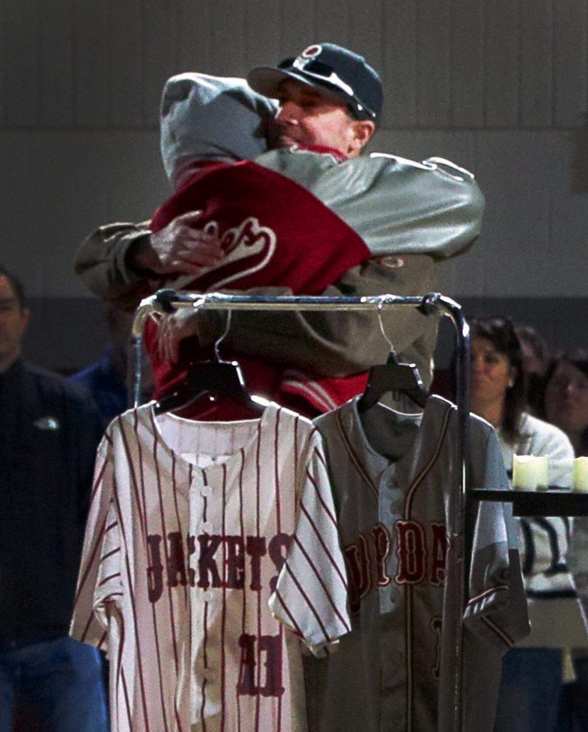 John Dimitri, facing camera, embraces former Jordan Vocational High School baseball player Darius Stokes during a Jan. 29, 2026, program honoring Dimitri’s twin brother, Tony, a former Jordan head baseball coach and co-athletics director who was the head baseball coach at Harris County High School when he died in an ATV accident Jan. 24.