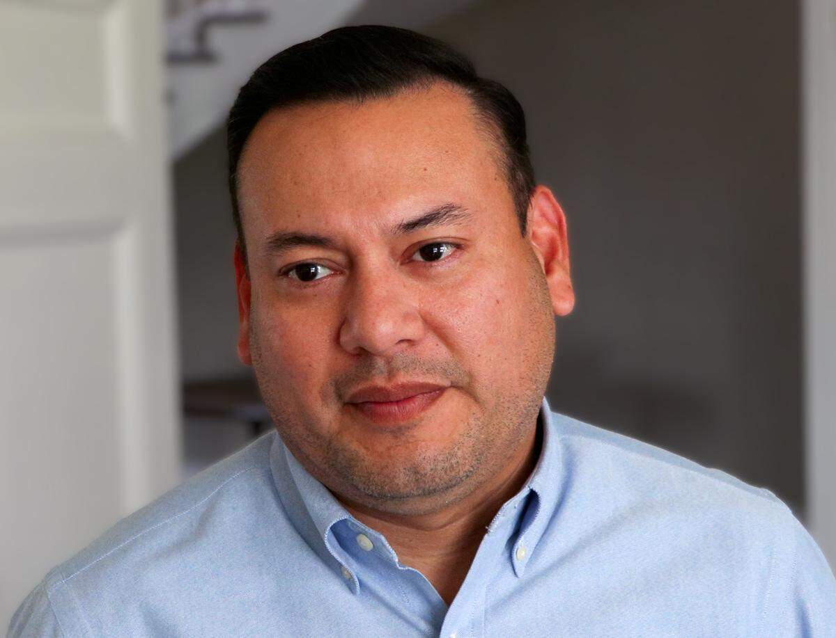 Julio Portillo, the executive director of MidTown Inc., talks July 9, 2025, about the new mural being painted on Extra Space Storage at Cross Country Plaza in midtown Columbus.