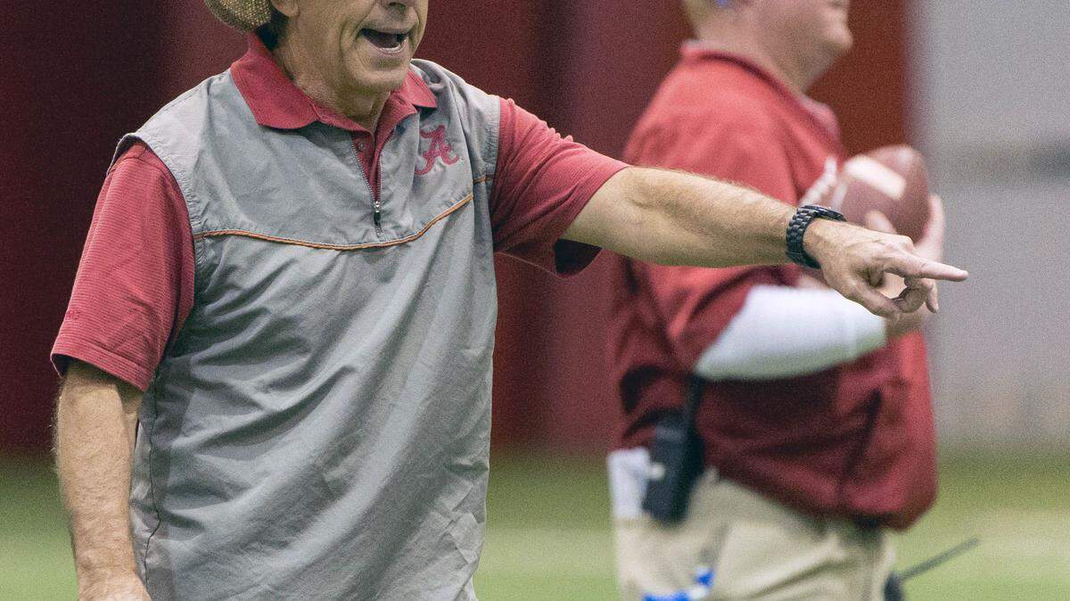 VASHA HUNT/AL.com via APAlabama football coach Nick Saban works with his players during football practice Dec. 1 at the Hank Crisp Indoor Facility in Tuscaloosa, Ala.
