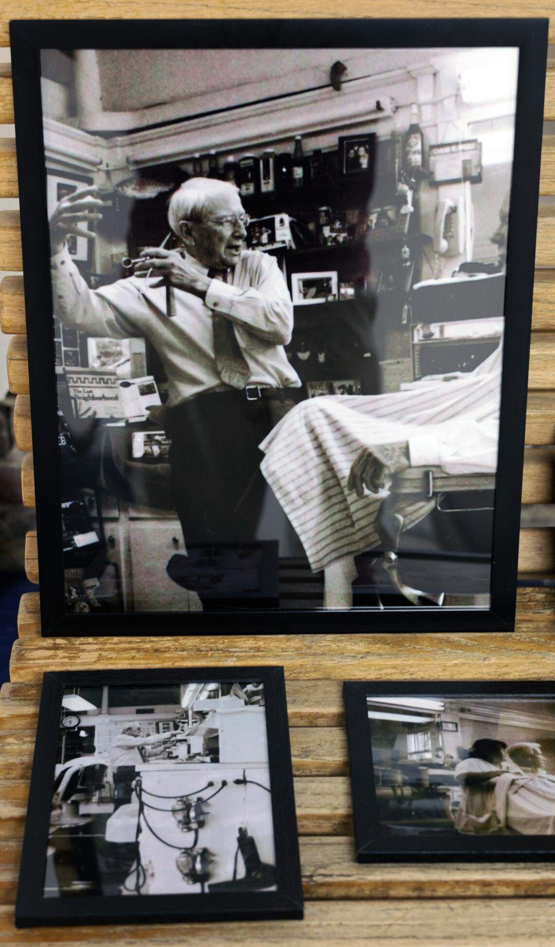 Several historical photos of the Blue J Barbershop, including some of former owner David McGee, top, wait to be added to the walls of the new Blue J, pictured Nov. 7, 2025.