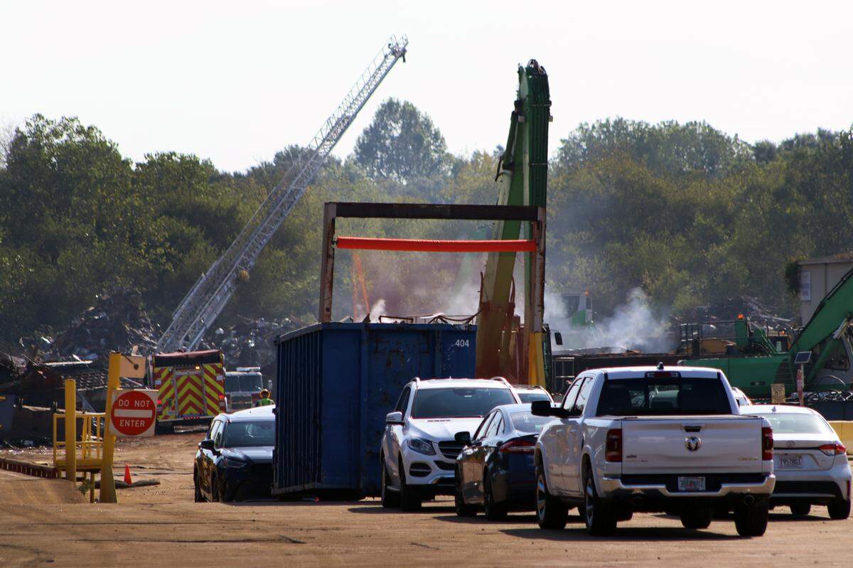 Light smoke continues burning, two days after the fire started at Radius Recycling. Fire crews were working to separate piles of burned debris.
