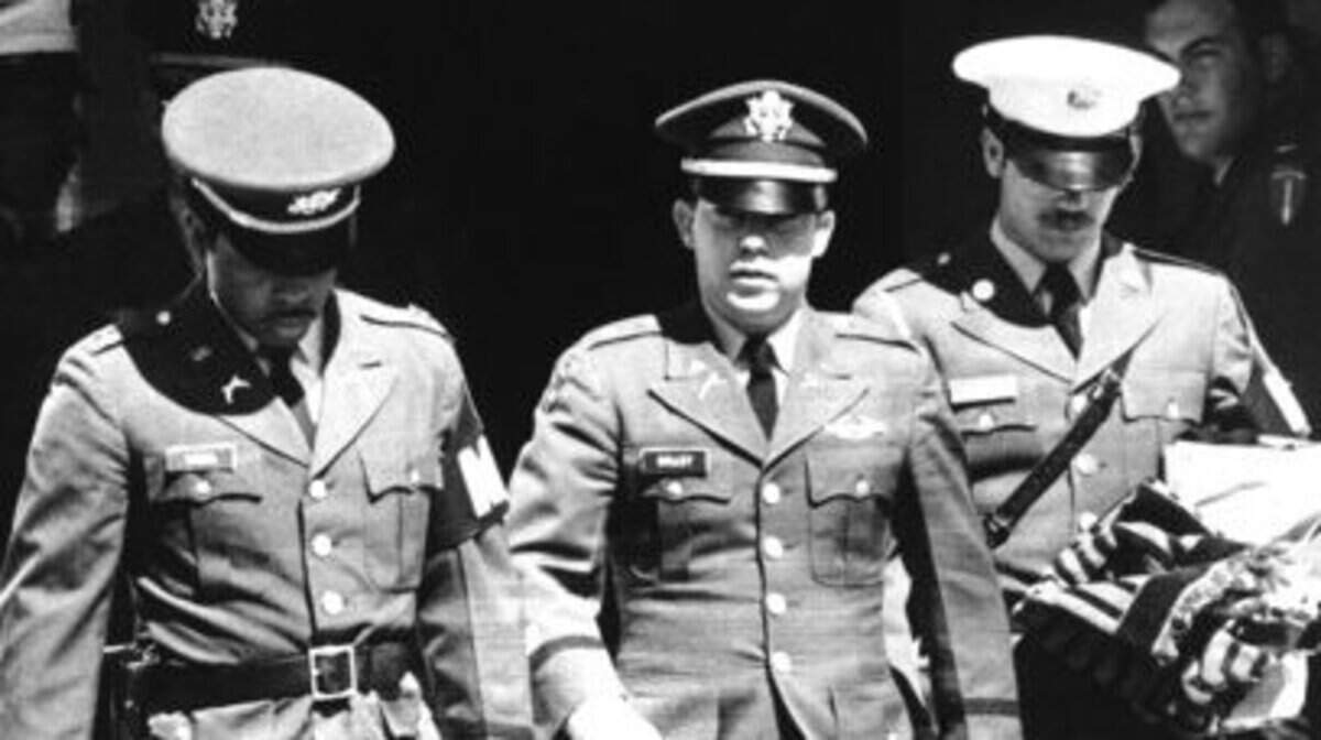 FILE - In this April 1, 1971, file photo, flanked by two military policemen carrying his personal belongings, Lt. William L. Calley, Jr., of Miami, Fla., leaves court at Fort Benning, Ga. after he was sentenced to life imprisonment. On March 16, 1968, U.S soldiers of Charlie Company, led by Calley, sent on what they were told was a mission to confront a crack outfit of their Vietcong enemies, met no resistance, but over the course of three to four hours killed 504 unarmed civilians, mostly women, children and the elderly, in My Lai and a neighboring community. (AP Photo, File)