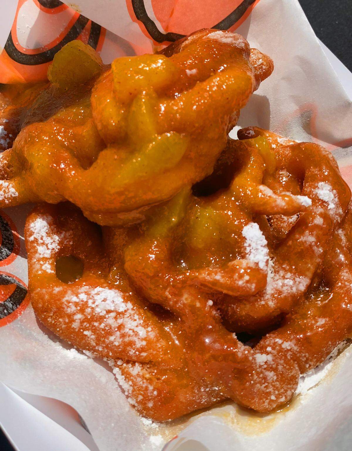 The funnel cakes at Synovus Park are topped with powered sugar, peach compote and a peach caramel sauce. 04/11/2025