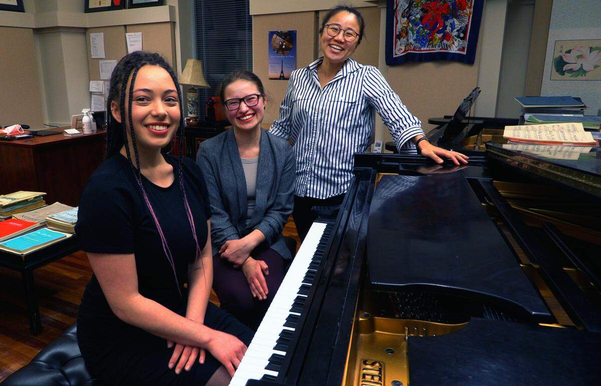 Nikol Bazalytska, left, and Anastasiia Zakharchenko, center, are Columbus State University students studying with Esther Park, right, associate professor of piano at CSU’s Schwob School of Music.