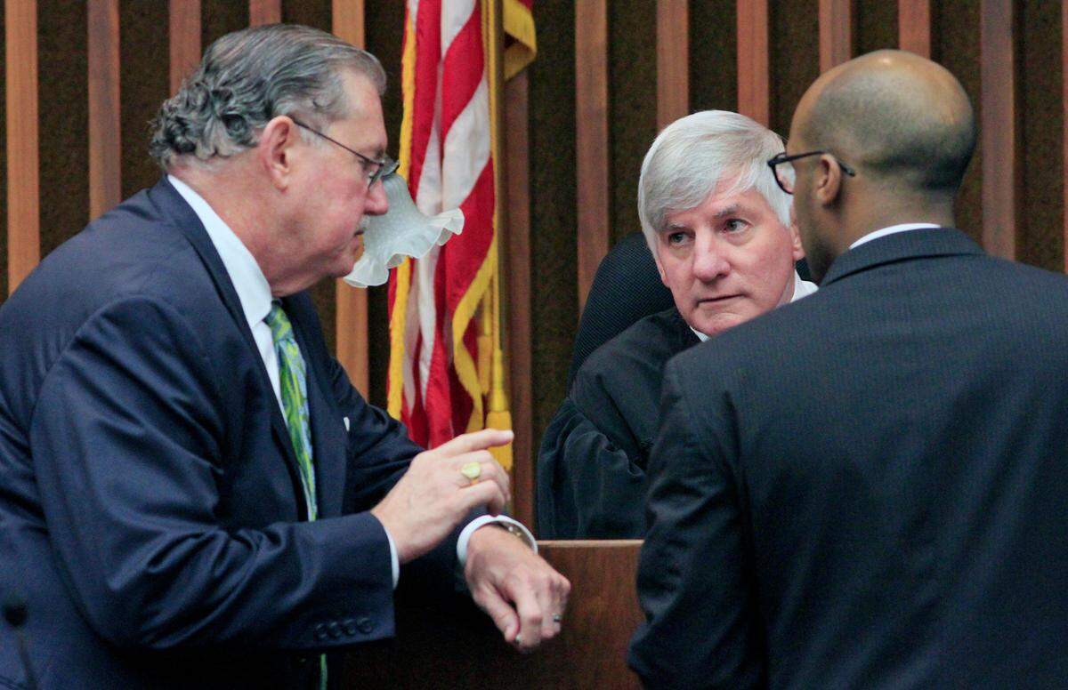 From left, defense attorney Richard Hagler, Superior Court Judge Bobby Peters and prosecutor Pete Temesgen confer at the bench during a 2015 trial in Columbus, Georgia. 05/15/15