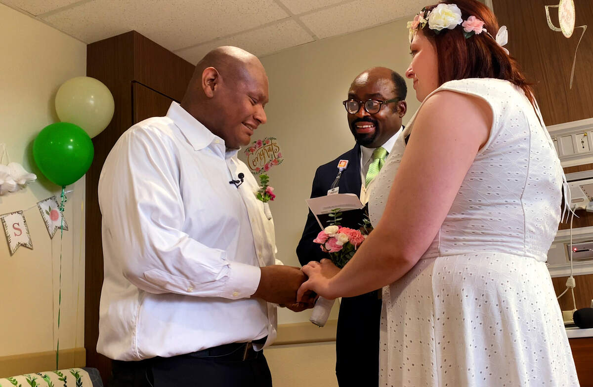 Alexander Ramirez Santos, left, married his fiancee Heather Renee Duke in his hospital room at Piedmont Columbus Regional’s Midtown Campus Wednesday afternoon. Pastor Marlon Scott officiated the ceremony. 07/20/2023