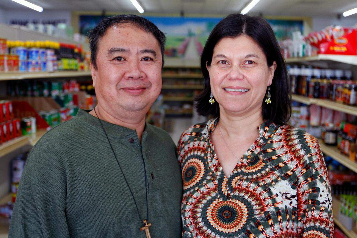 Tuan Clay, owner of Oriental Food & Gift at 4508 Armour Road, in Columbus, and his wife Kim pose for a portrait in the store Friday January 15, 2021.