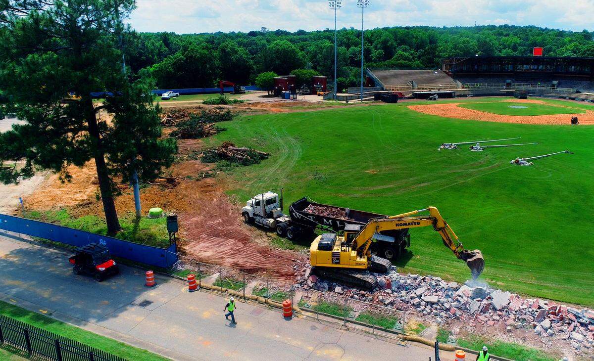 One pine tree was left due to workers fearing they may hit the stadium light when removing the tree. Workers took down trees and demolished the outfield wall Tuesday at Golden Park in Columbus, Georgia. 05/07/2024