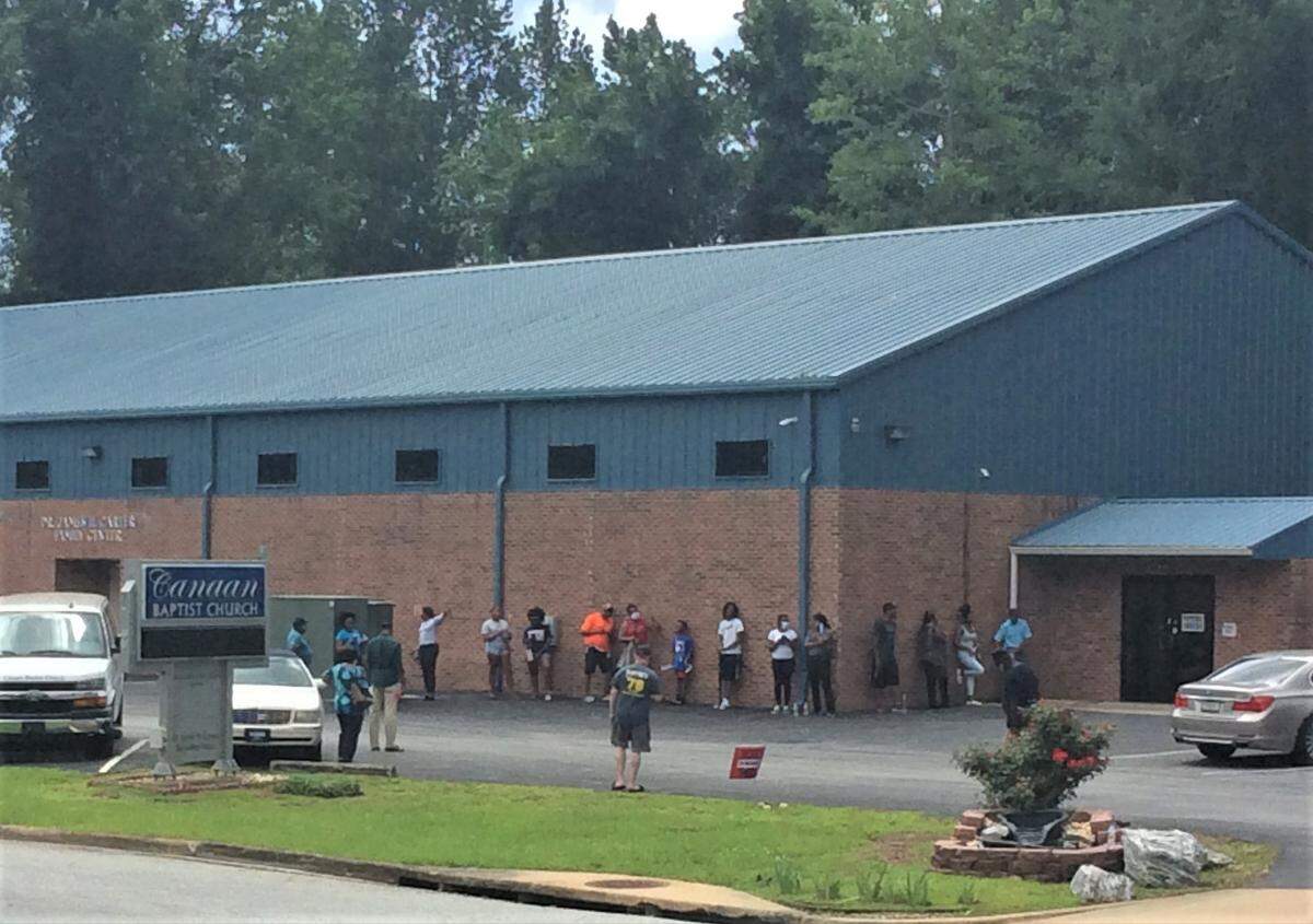 Voters stand in line outside of Canaan Baptist Church on Election Day, June 9, 2020. Some voters at the precinct reported waits of one to two hours to cast their ballot.